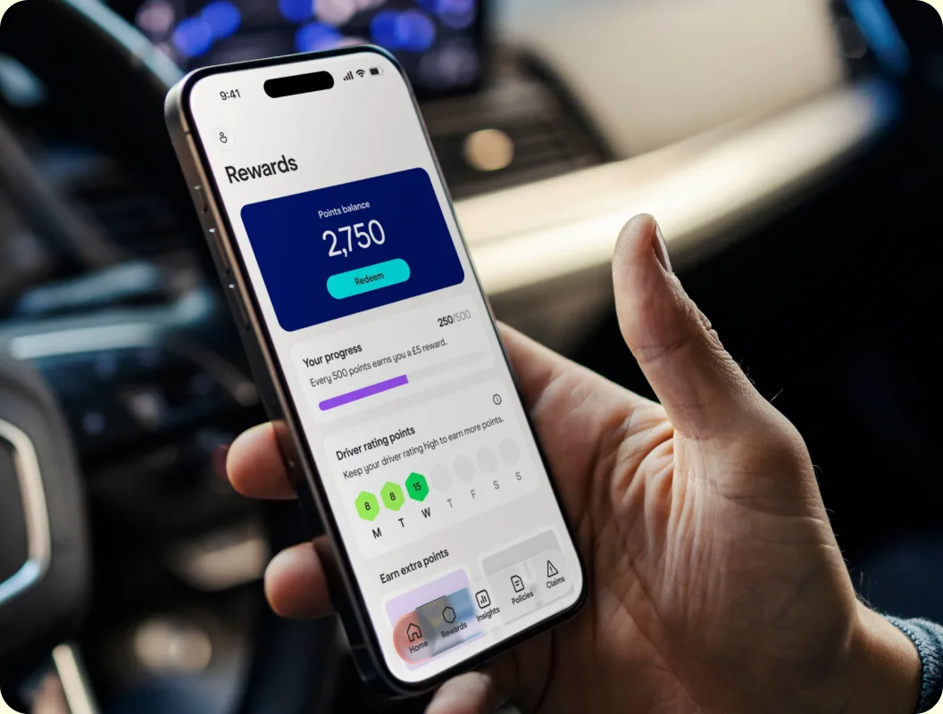 A driver holding a phone showing the Zego app rewards screen with a points balance